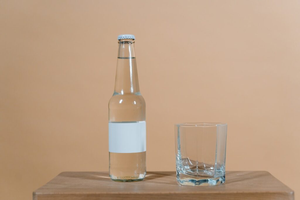 Empty Glass and Bottle with No Label